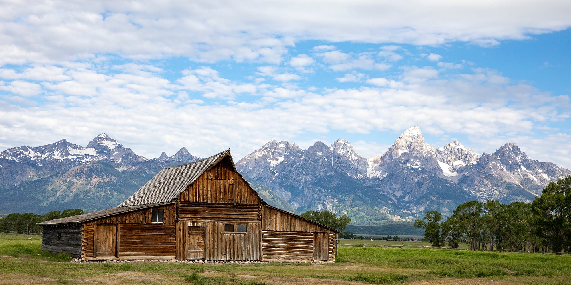 Fine art photography print of the T.A. Moulton Barn with the Teton Range in the background, perfect for rustic home decor.