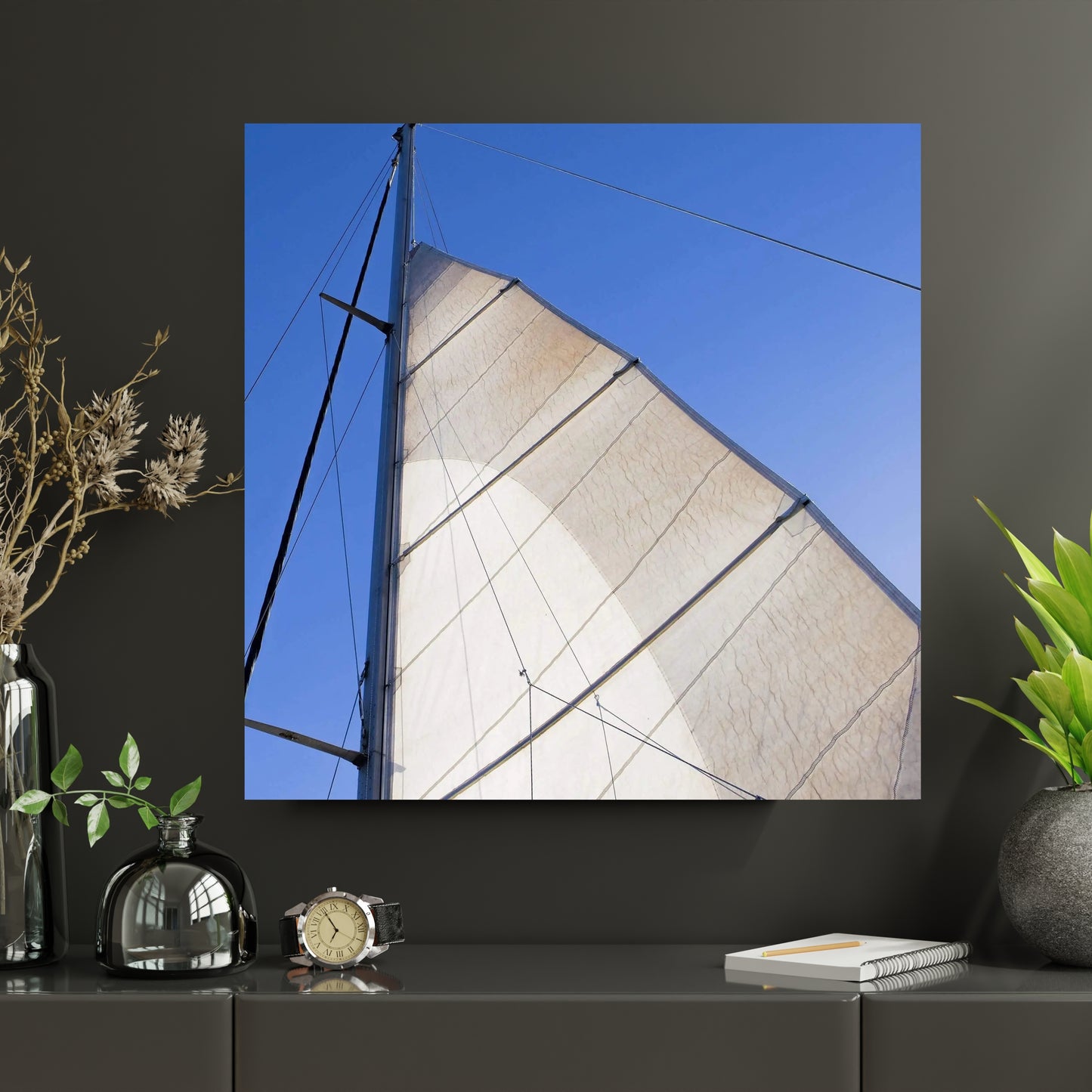 large art of sailboat sail and mast hanging above a shelf in bedroom or office