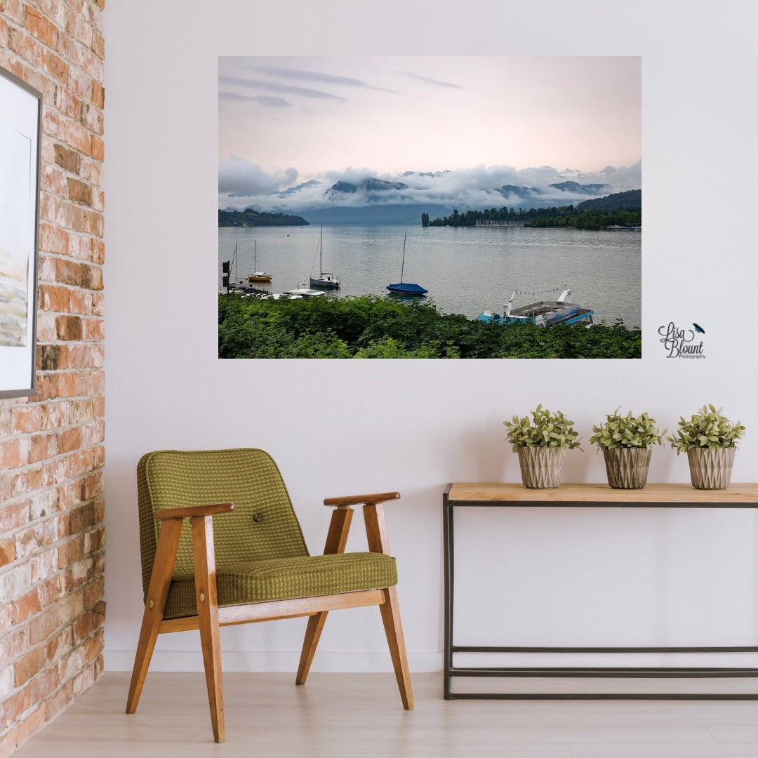 Lake Lucerne on a foggy morning large art hanging in a room with white walls, green chair, and light red brick