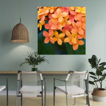 light mint green wall has large art of orange coral and peach colored flowers hanging above a table and chairs