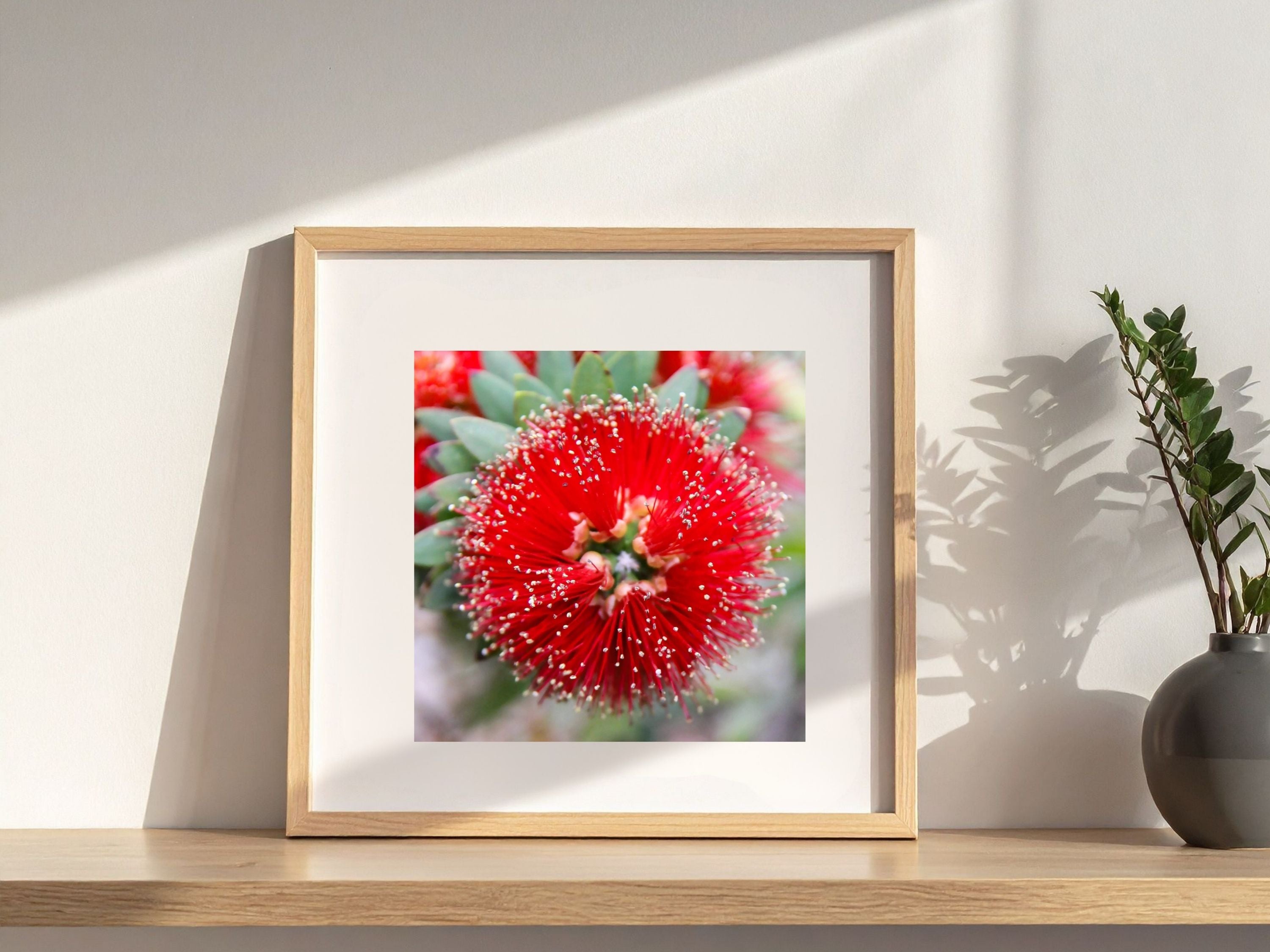 Red botanical metal wall art styled in southwest-inspired interior with warm neutrals