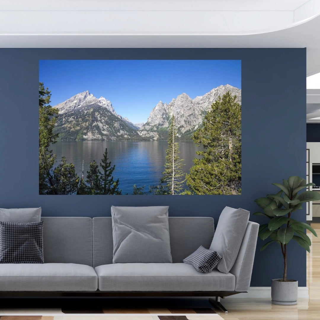 Large-scale mountain lake landscape wall art anchoring a modern healthcare or office waiting room with calming blue tones.