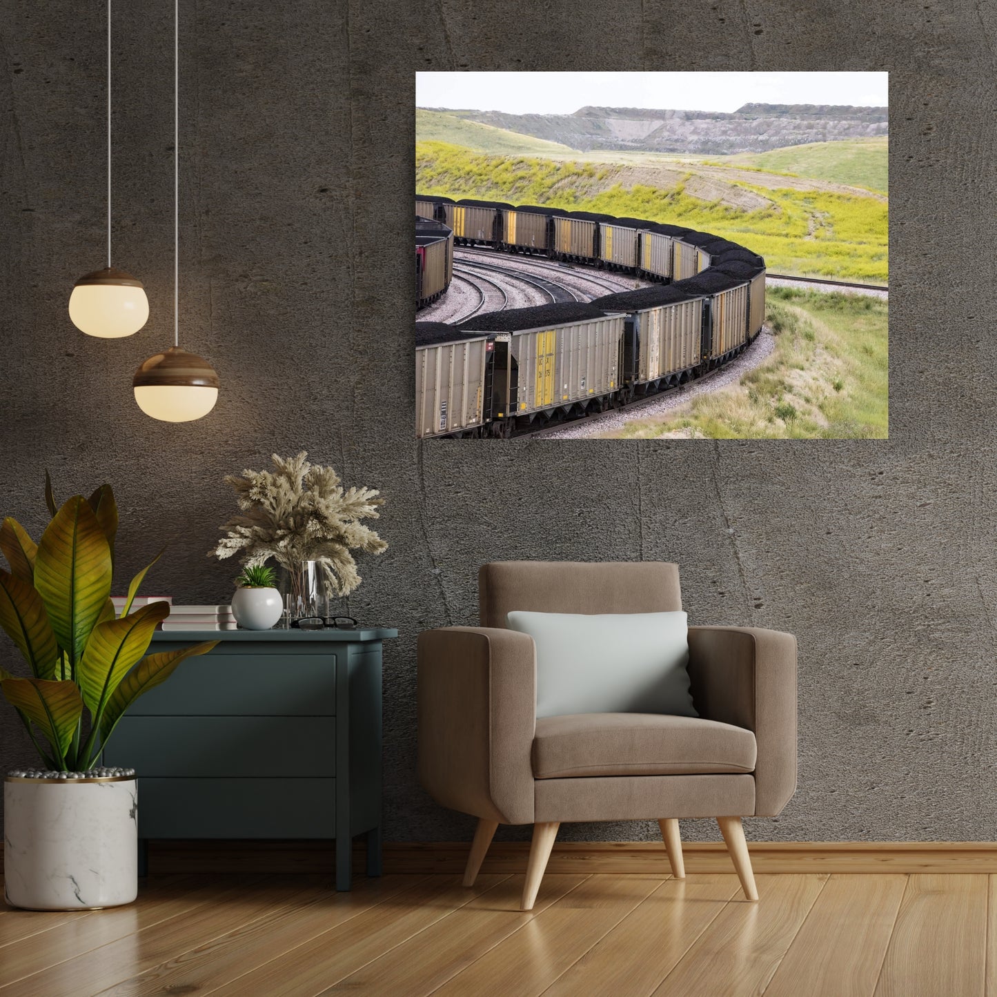 brushed metal abstract art of coal cars in circular form hanging in dark neutral colored sitting area