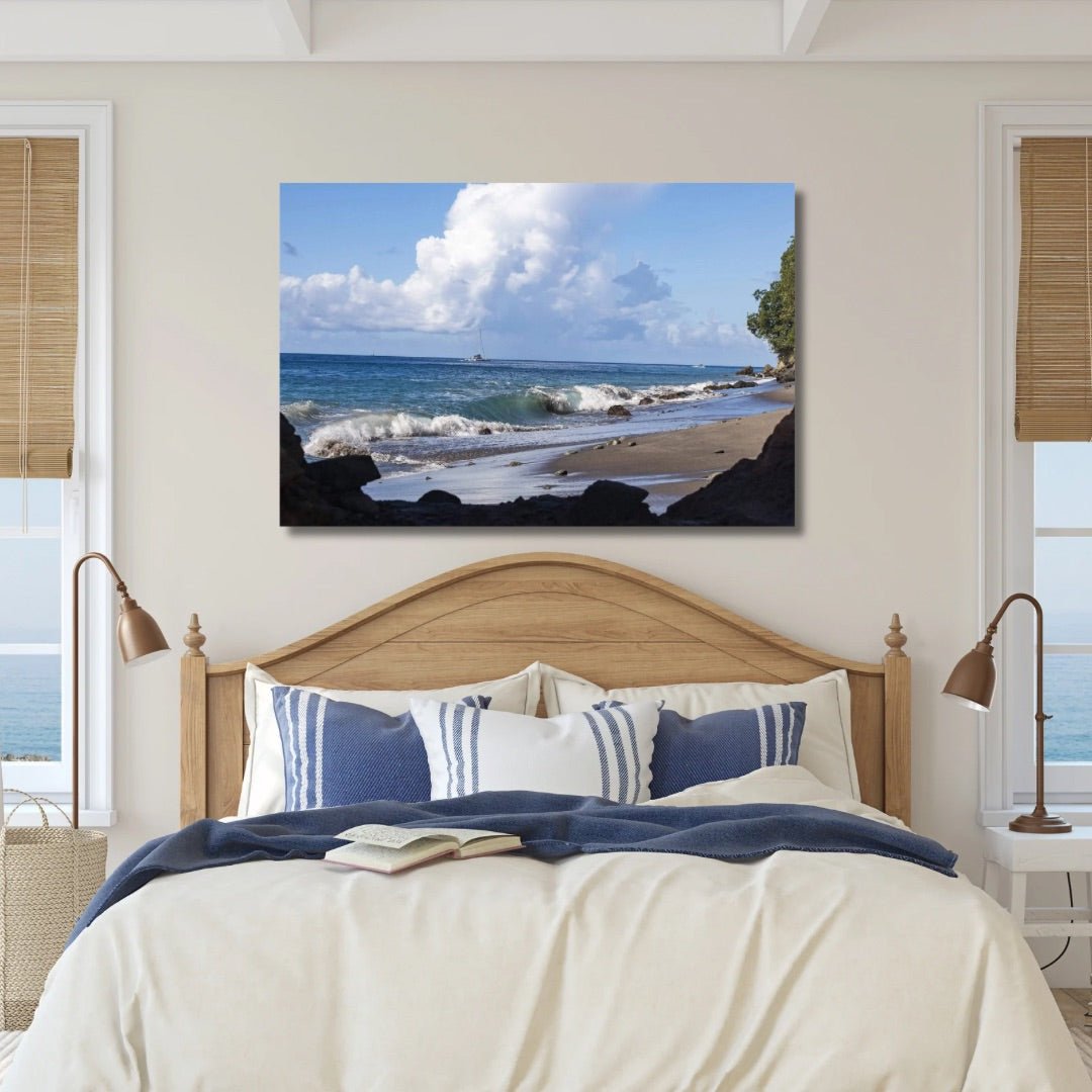 Large coastal wall art above a bed featuring Color of St. Lucia Coast with blue Caribbean water and dramatic clouds.