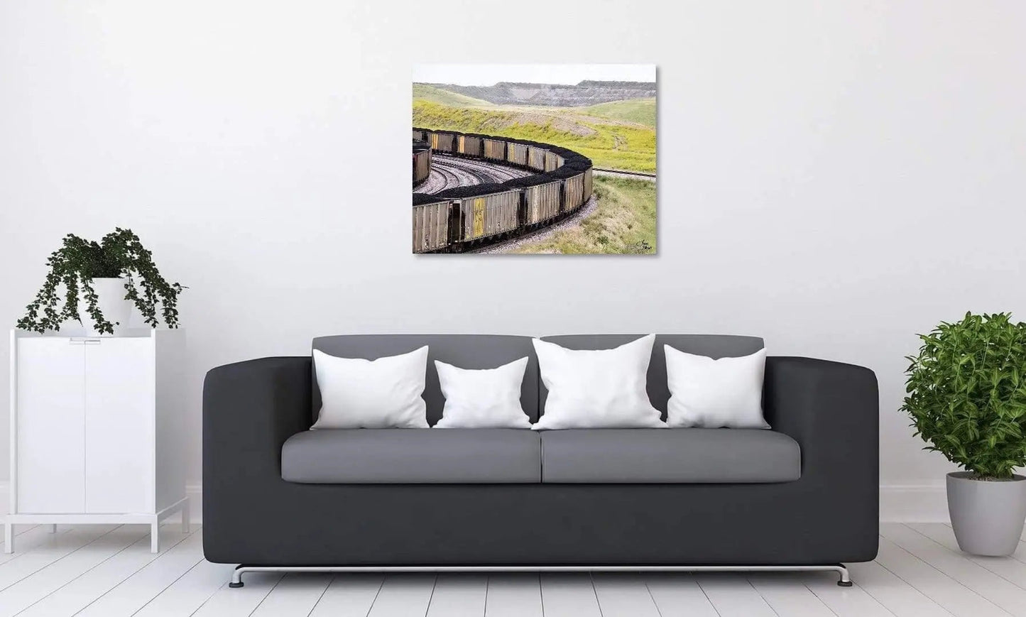 Landscape coal cars on brushed metal wall display above couch