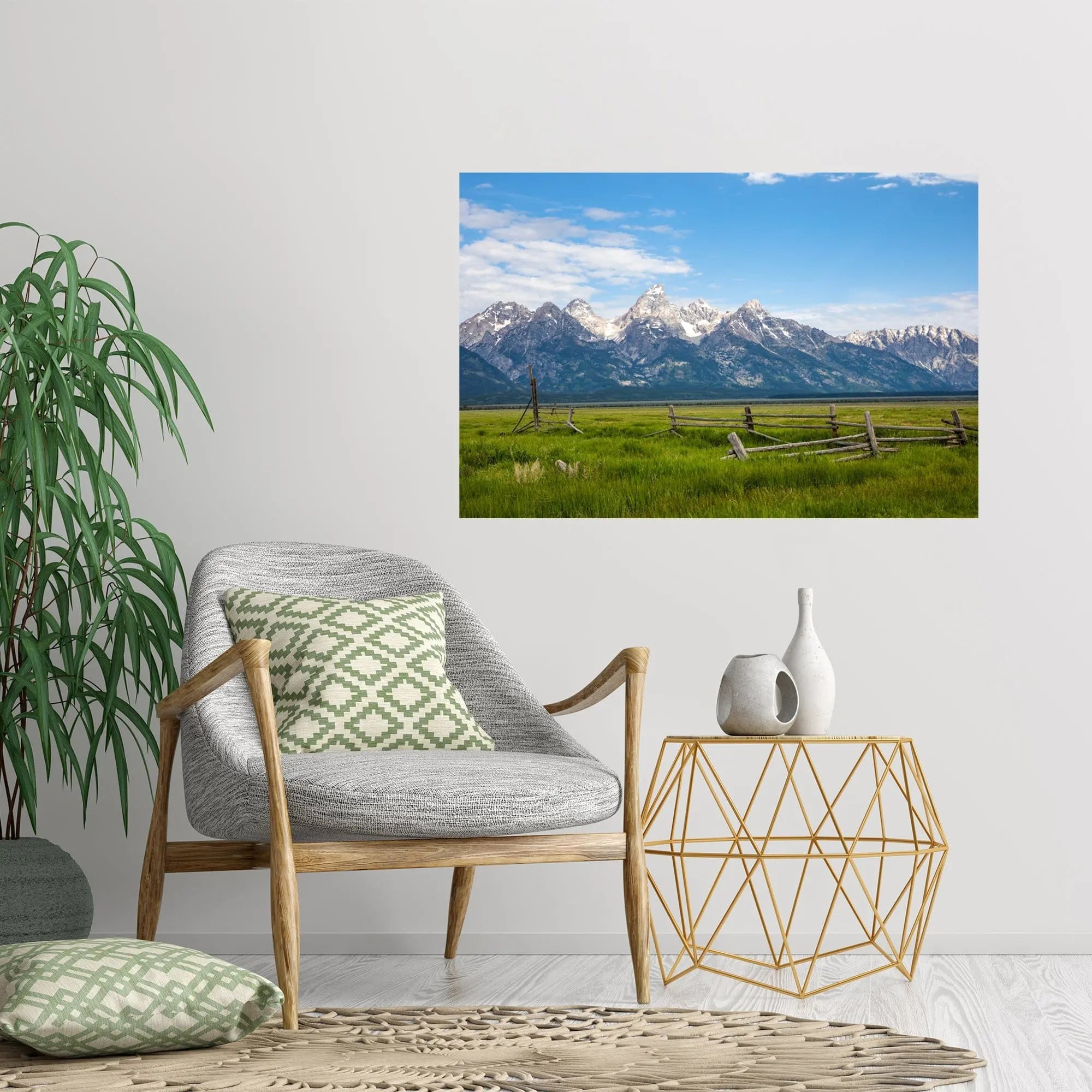 Art of Grand Tetons landscape with a rustic wooden fence hanging on a wall in casua setting with gray chair green accents