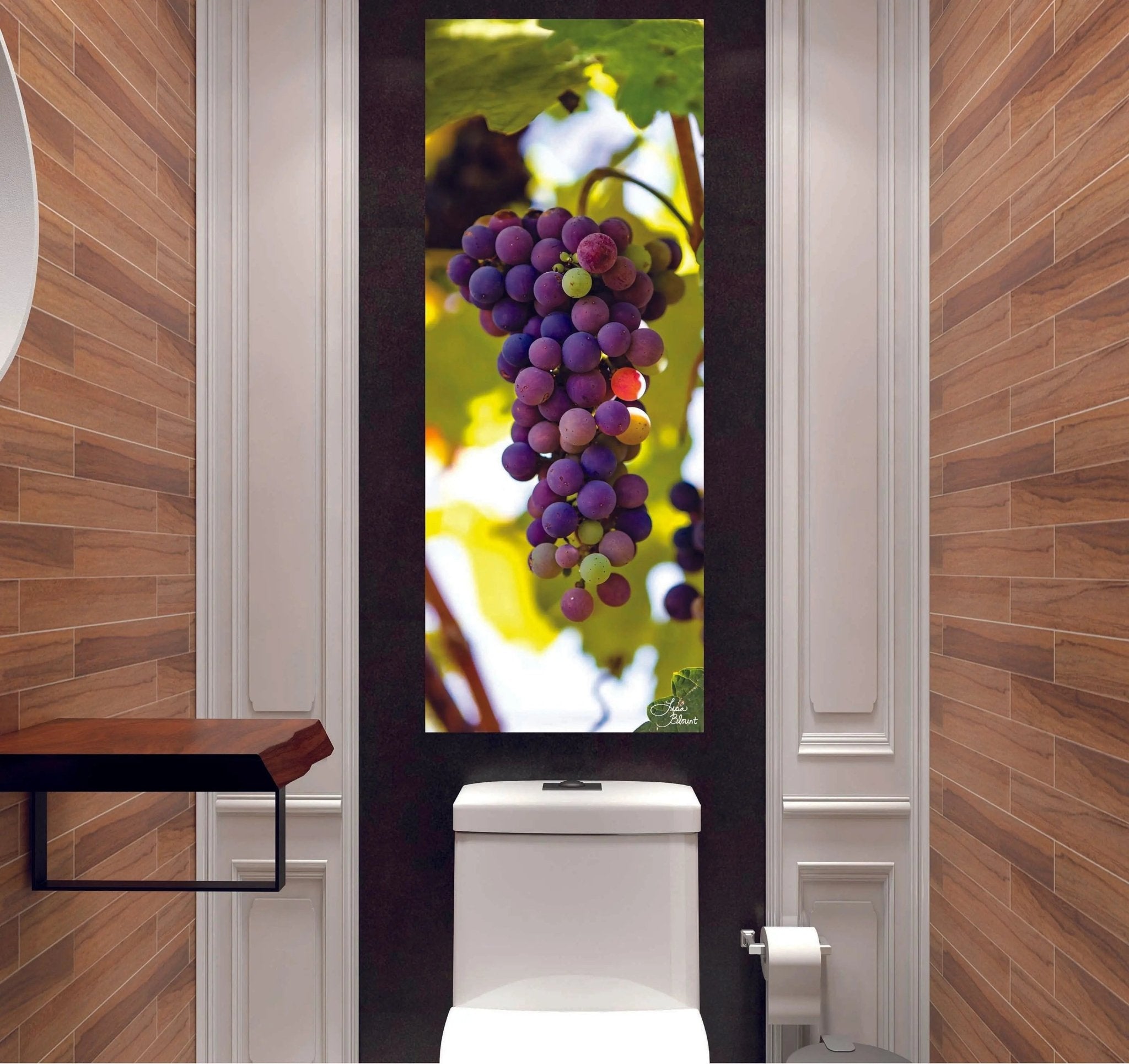 Vibrant Napa Valley grape wall art installed in a narrow hallway-style powder room with warm wood paneling.