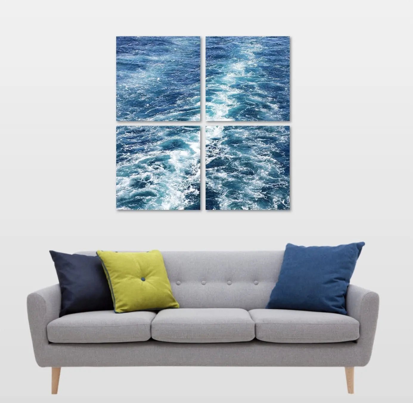 Four-panel grid layout of Color of Blue Ocean Waves displayed above a contemporary sofa — abstract deep-blue water textures for modern coastal décor.