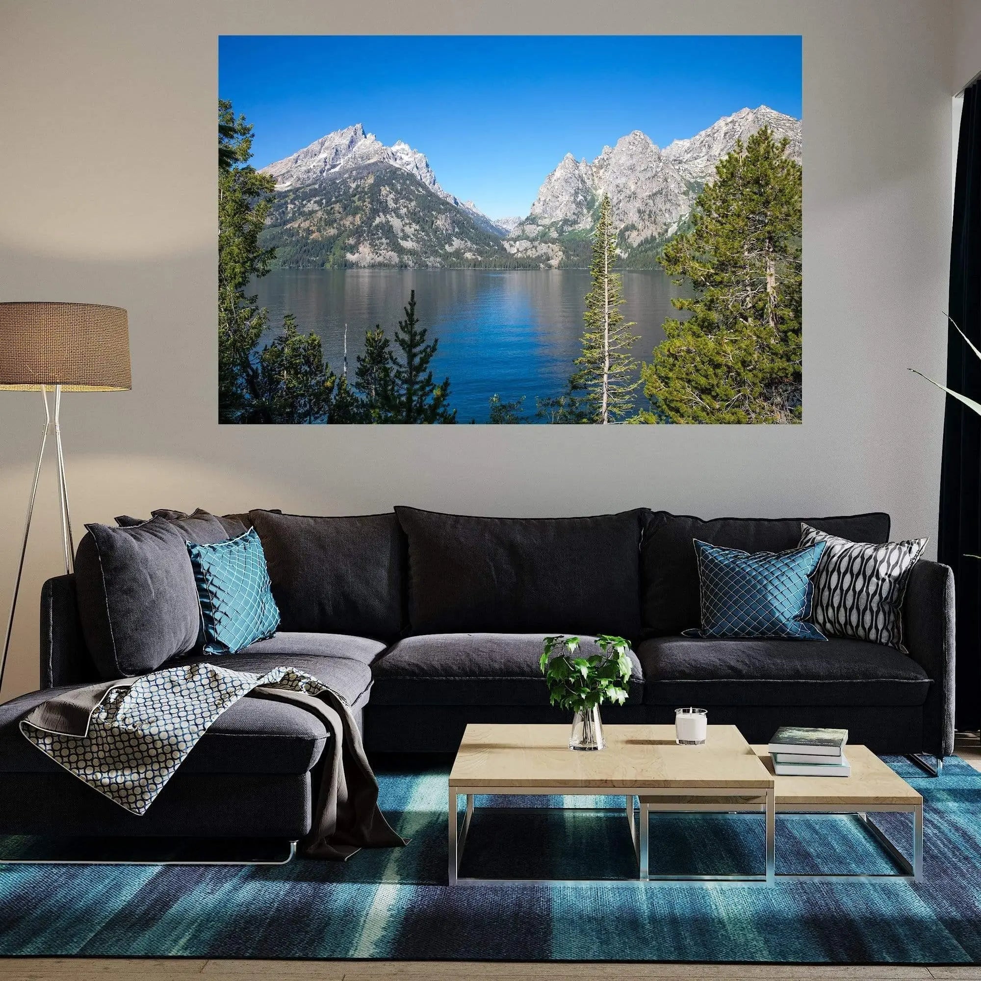 Jenny Lake fine art photography displayed in a modern living room with a blue accent wall and gray sofa.