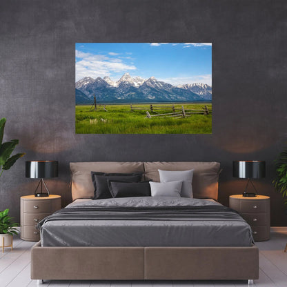 Grand Tetons and green field art above bed in a dark brown bedroom setting
