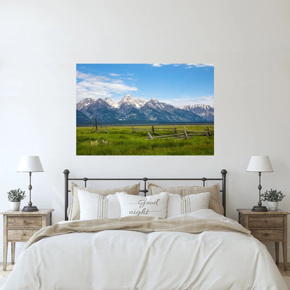 Rustic bedroom wall art of Grand Tetons with a wooden fence and green pastures in front
