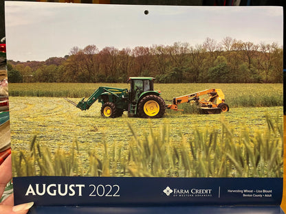 lisa blount art harvesting wheat on the august page of farm credit calendar 2022