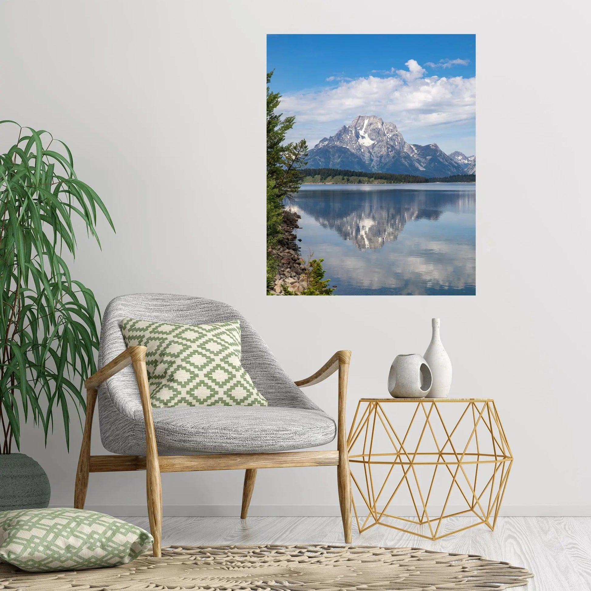 Large art of Jackson Lake displayed on a wall behind gray chair green accent