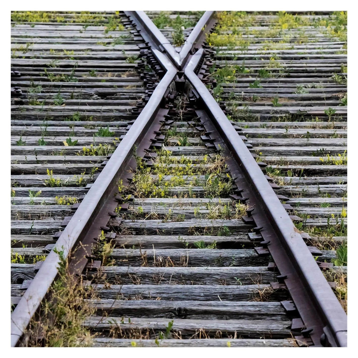 Train track in shape of X art on brushed metal home decor