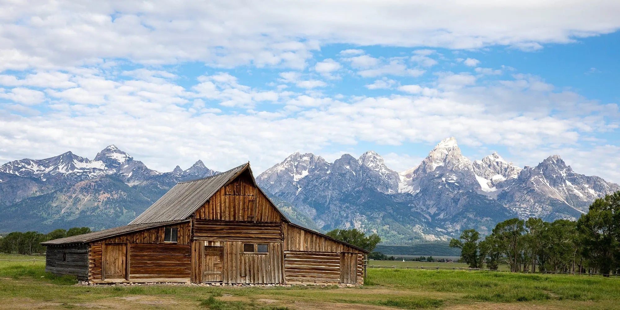 TA Moulton Barn at Mormon Row with the Grand Teton mountain range—rustic Western landscape fine-art photography.