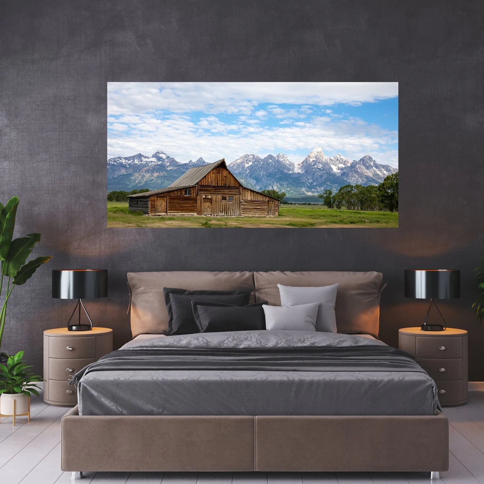 TA Moulton Barn fine art photograph displayed above a modern gray bed, styled with warm wood nightstands and dark textured walls.