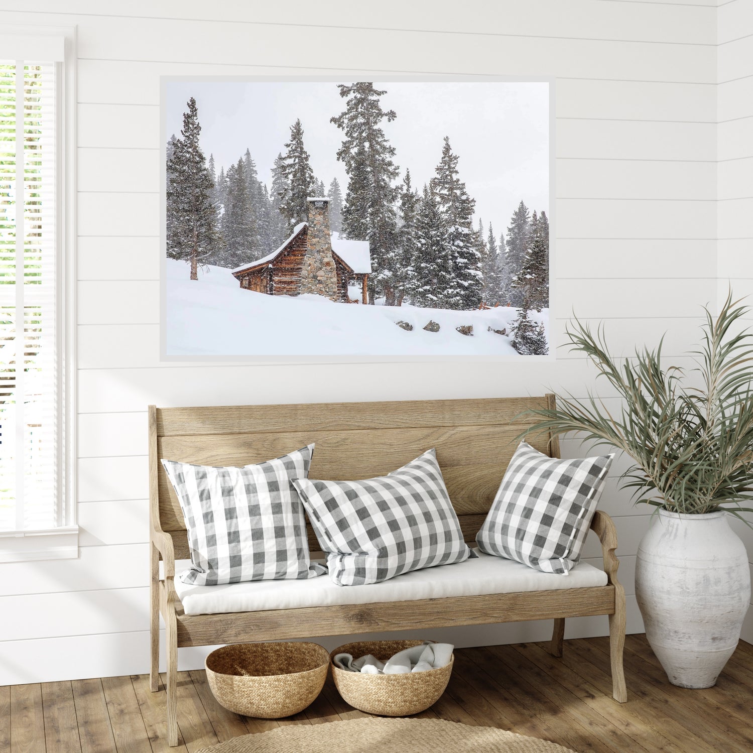 Large canvas print of rustic snow covered cabin in Colorado hanging in a farmhouse themed room.