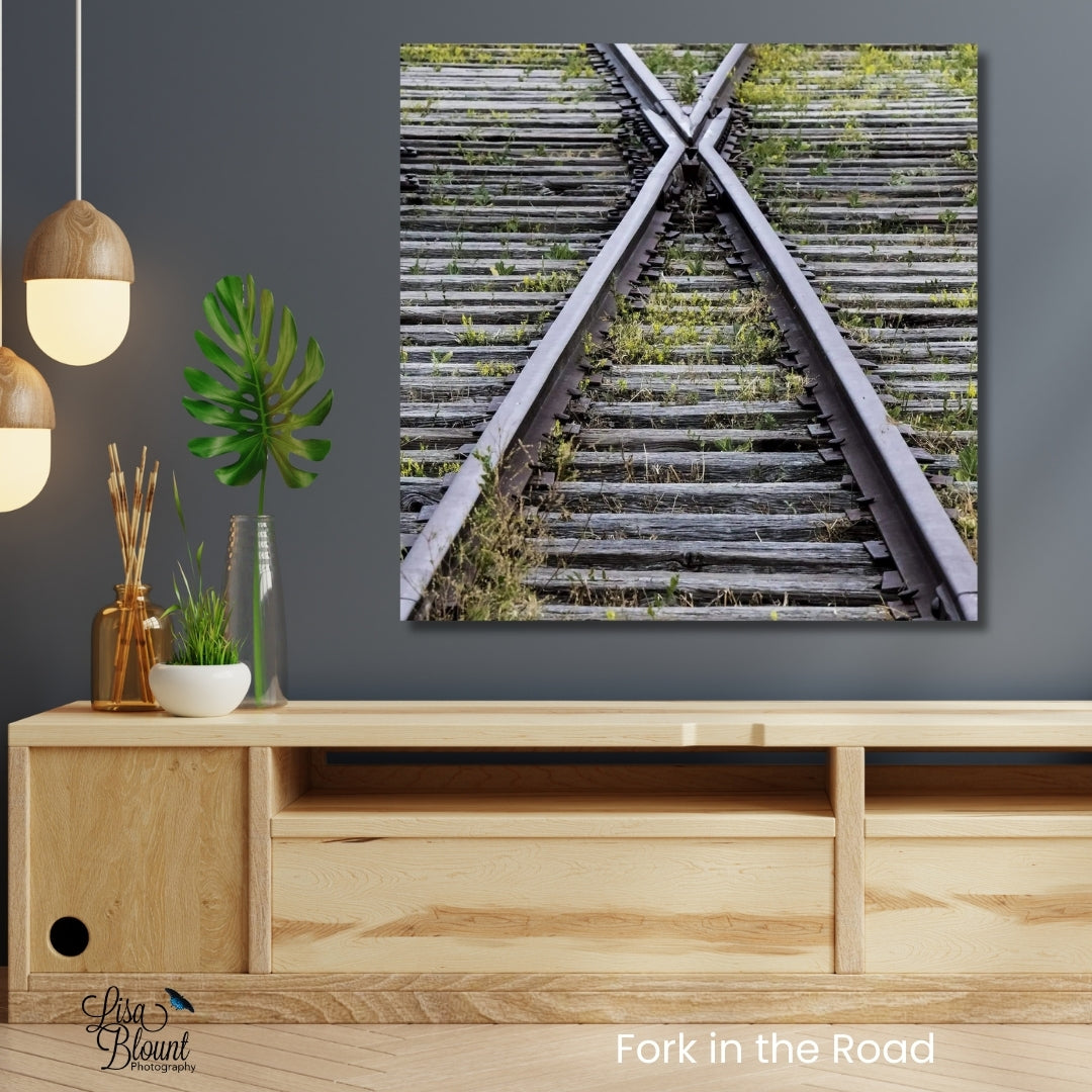 Railroad track fork wall art on brushed metal above console in modern industrial room