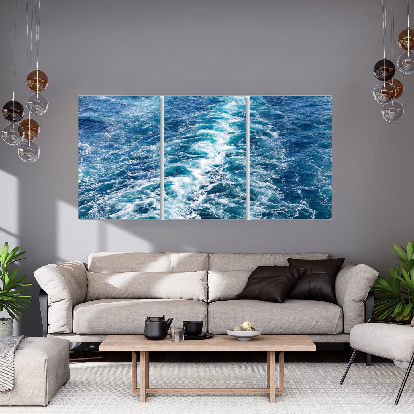 Nautical blue and teal ocean wave art in a triptych form hanging on a tray wall above a couch