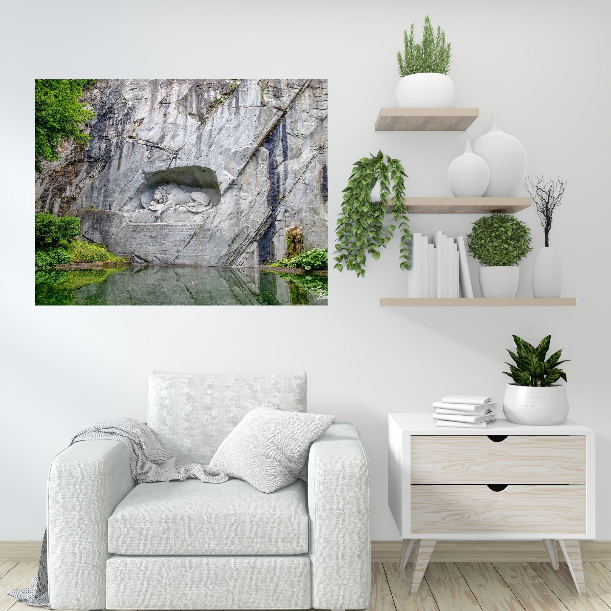 Art of lion monument in Lucerne Switzerland featured on a white wall with lots of green plant accents