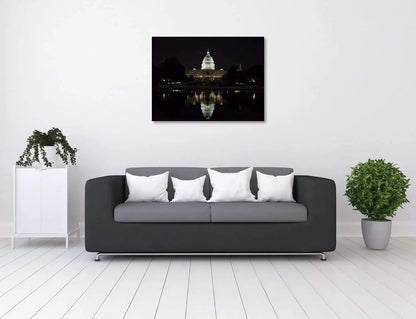 US Capitol reflecting at night during budget debate with flag raised