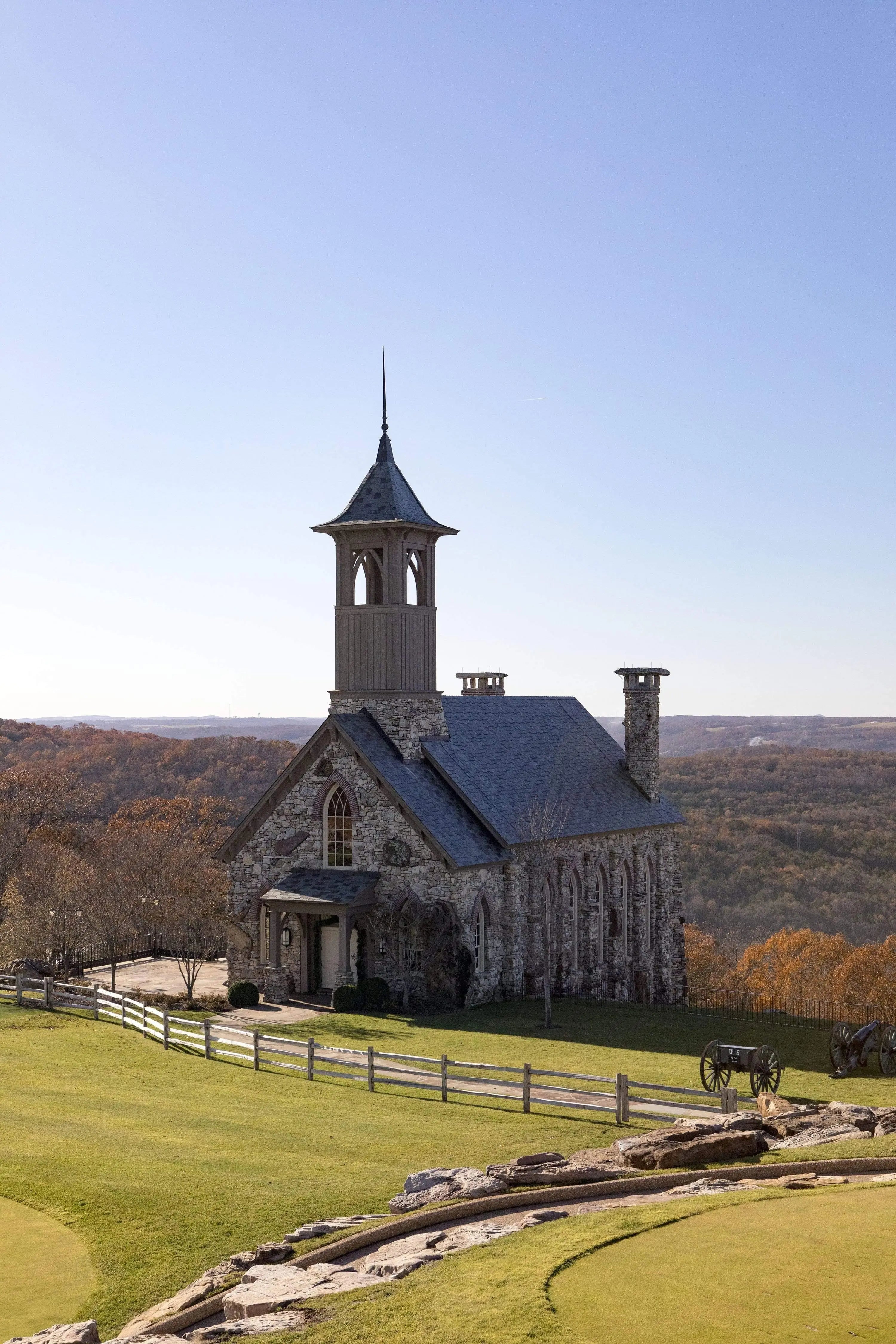 Stone Chapel of the Ozarks surrounded by peak fall foliage—fine art church photograph from Top of the Rock, Missouri