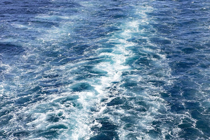 Abstract blue ocean photography wall art print of waves, captured at sea—part of a coastal fine art photography collection by Lisa Blount
