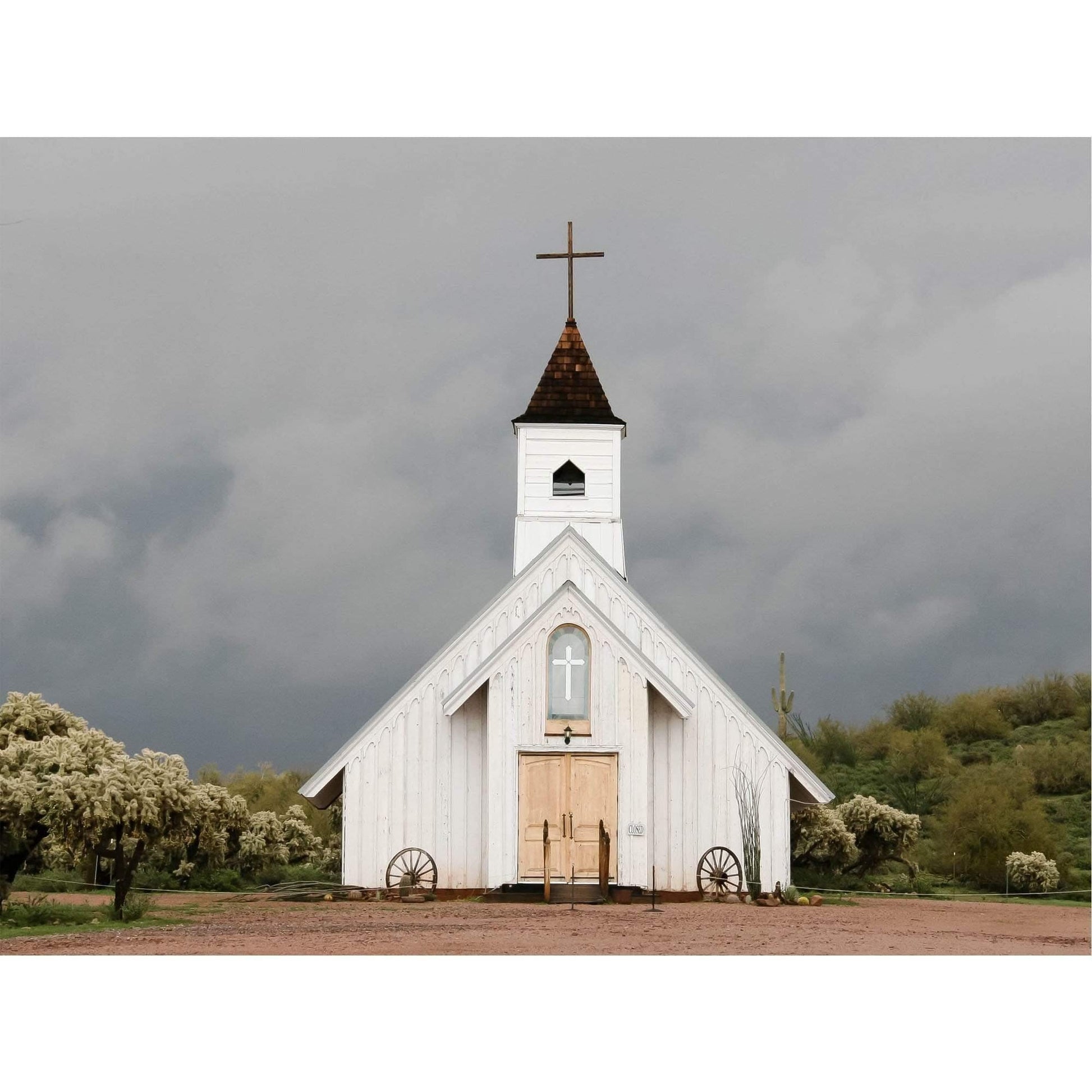 Fine art photography print of a rustic white country church under dramatic stormy skies, titled 'Spiritual Warfare.'